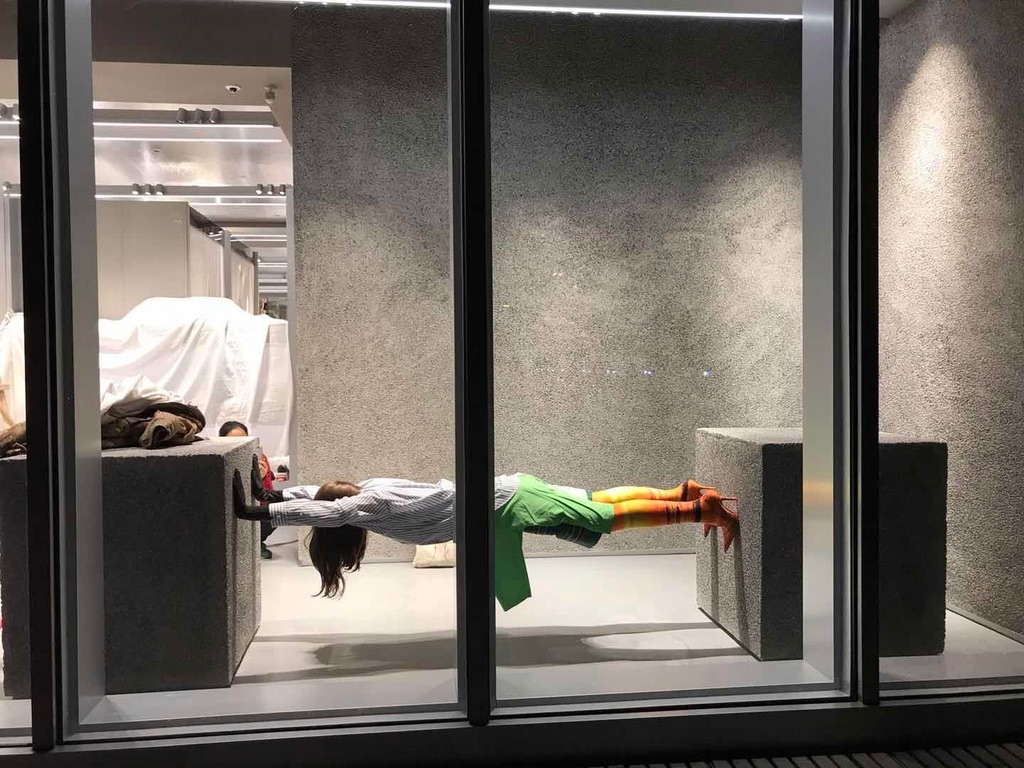 Figure held between two blocks in the Colette window