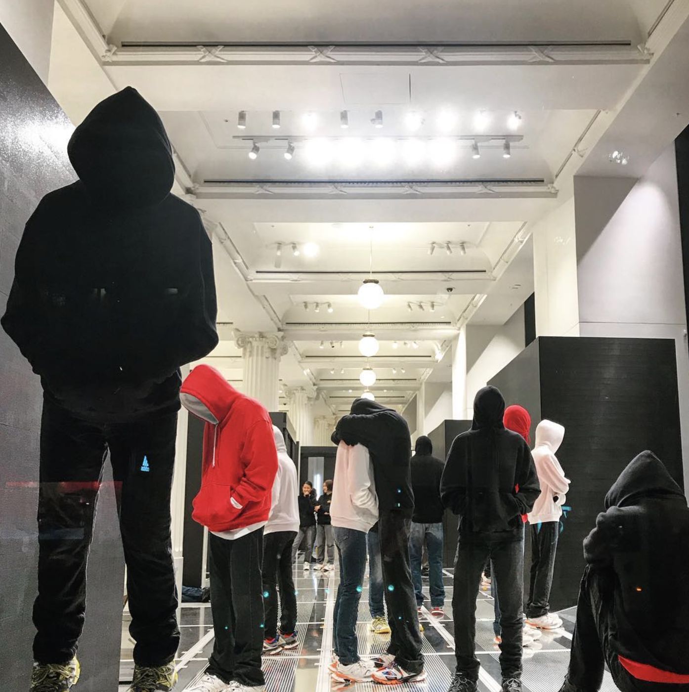Figures in the Selfridges Corner Shop, reflective floor and black panels